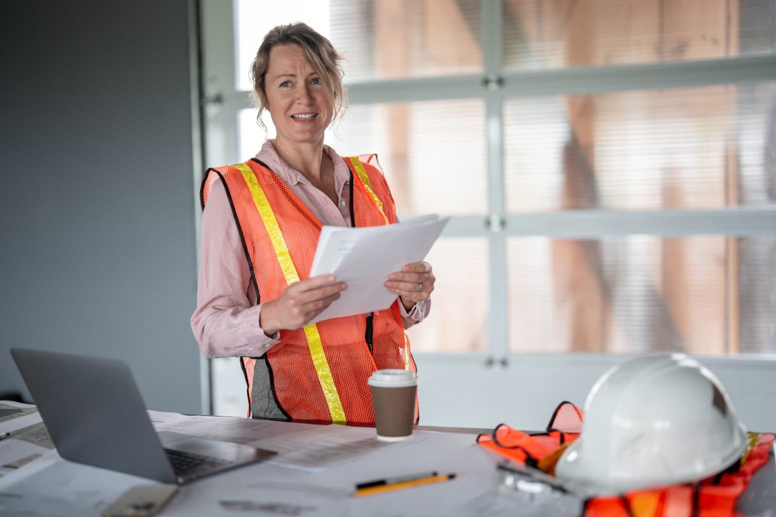Project manager reviews drawings and submittals in a construction site office